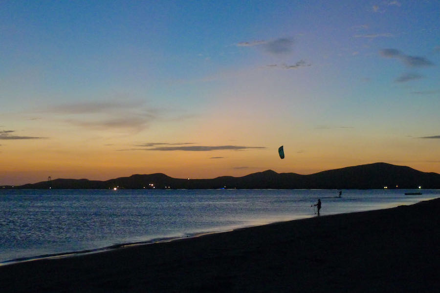 Two people kitesurfing in Cabo de la Vela, one of the best beaches in Colombia for kitesurfing.