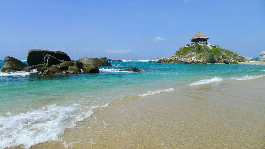 A beach shelter sits on the rocks above Cabo San Juan beach in Colombia.
