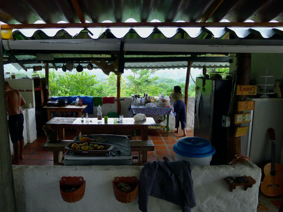 A person looks out at the mountains from an outdoor hostel kitchen in Minca, Colombia.