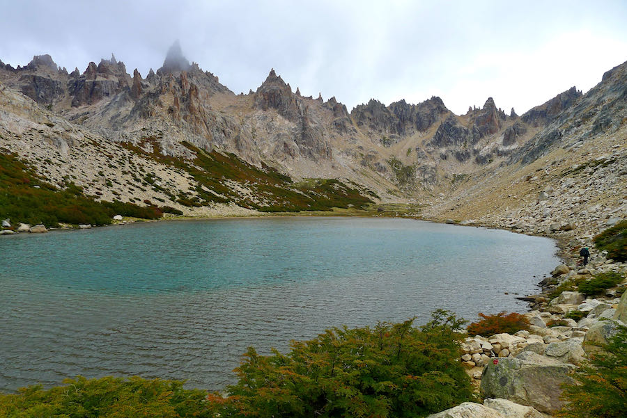 A solo hiker trekking in Bariloche next to Laguna Toncek.