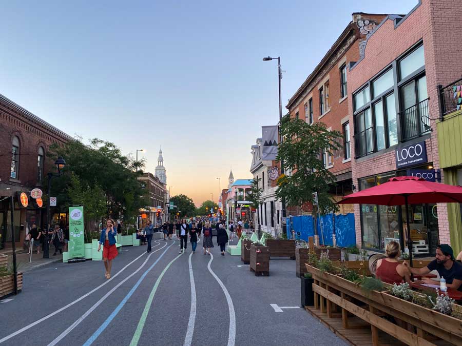Pedestrians and diners enjoy lively Mont-Royal Avenue in late summer, one of the best times to visit Montreal.