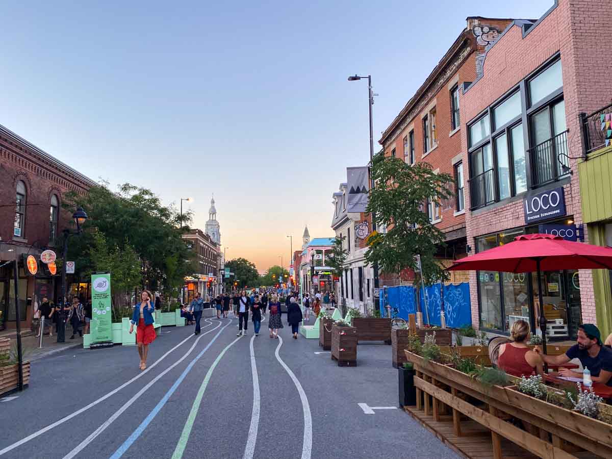 Pedestrians and diners enjoy lively Mont-Royal Avenue in late summer, one of the best times to visit Montreal.