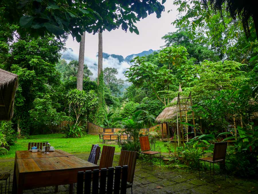 Mountains shrouded in mist viewed from an outdoor table at Chiang Dao Nest.