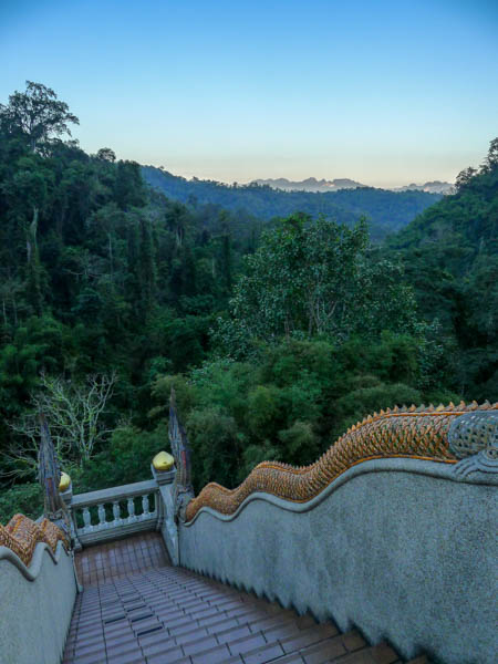 Stairs to Wat Tham Pha Plong forest temple, with mountains in the distance.