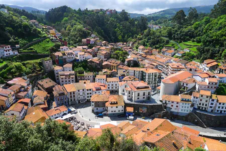 The green hills of Asturias and terracotta roofs of Cudillero viewed from Mirador de la Garita.