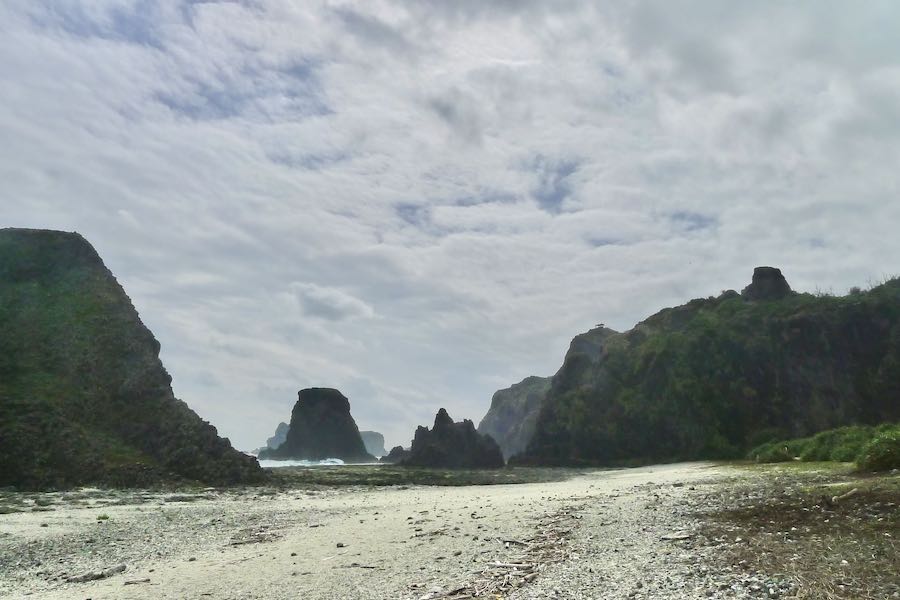 Large, towering rocks rising from the beach at Youzihu.