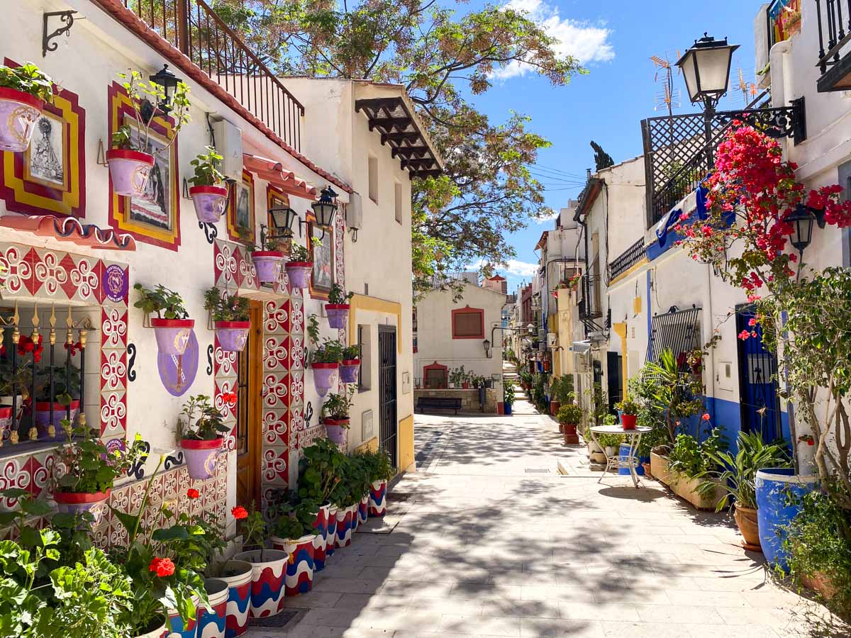 Flower pots and colorful tiles in the Santa Cruz neighborhood - a must for any Alicante itinerary.