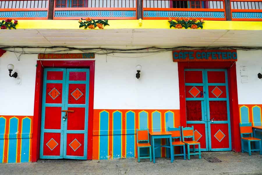 Brightly colored doors, tables, and matching chairs in the main plaza of Jardín, one of Colombia's most beautiful small towns. 