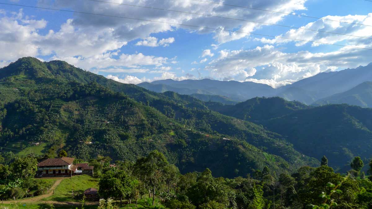 The green mountains of Antioquia department covered with coffee and banana plants, the most beautiful place on this Colombia itinerary.