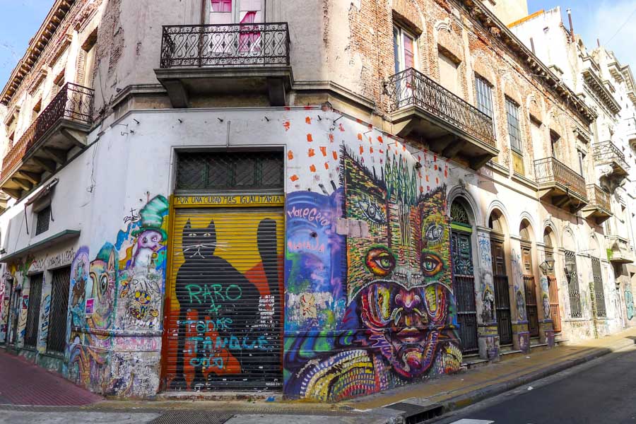 Colorful street art on crumbling buildings in San Telmo, Buenos Aires.