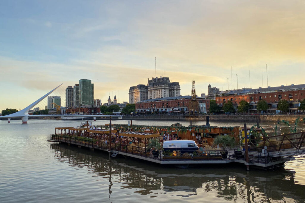 A floating bar in the Puerto Madero waterfront district with the Puente de la mujer in the background.