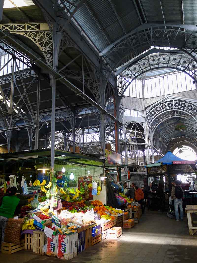 A fruit stand and coffee kiosk at the San Telmo Market - a recommended stop on a 4 day Buenos Aires itinerary.