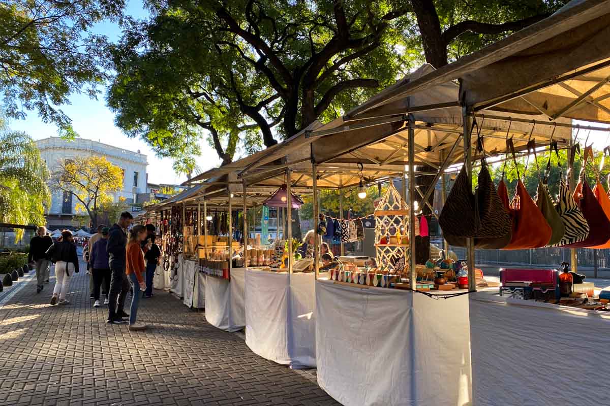 People peruse the handicrafts on display (including leather bags, mate gourds, and jewelry) at the Plaza Serrano weekend market.