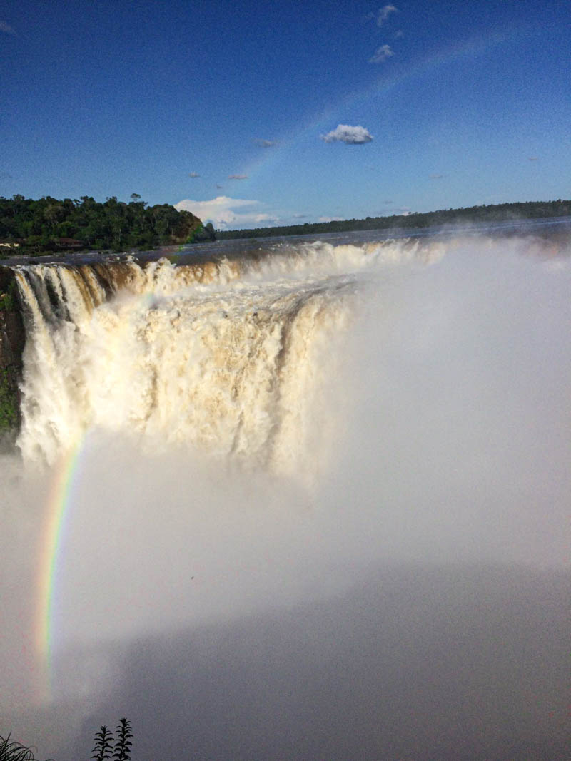 A rainbow in the waterfall's spray at the Devil's Throat viewpoint at Iguazú Falls.