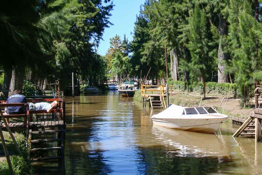 Small boats and docks in a small waterway in the Tigre River Delta.