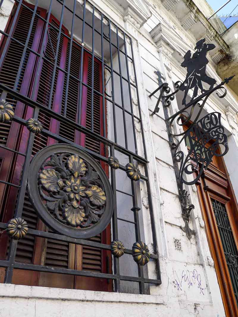 Window bars decorated with iron work and tango sign in Buenos Aires, Argentina.