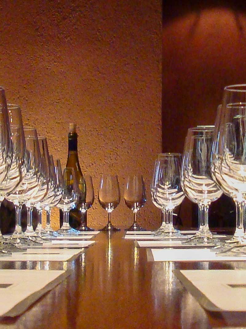Empty wine glasses on a table before a wine tasting in Mendoza.
