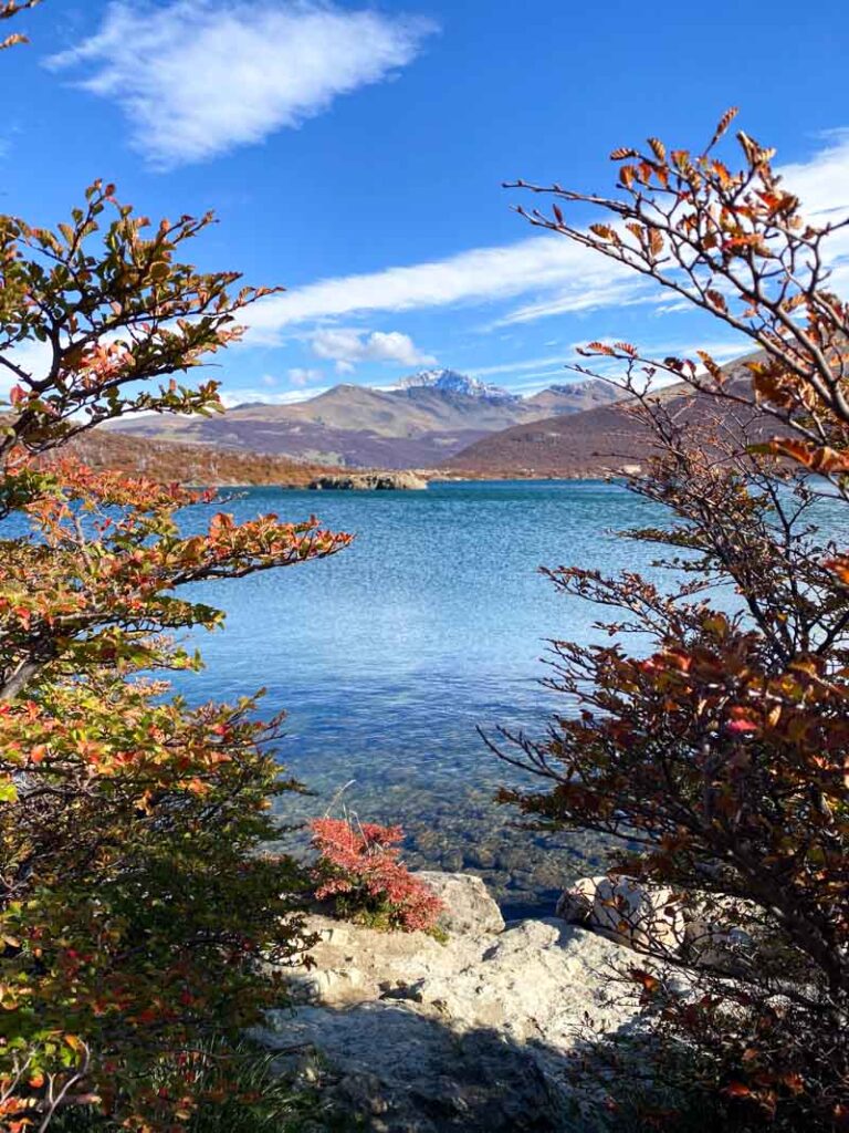 Gorgeous view of Laguna Capri framed by red and orange autumn leaves.
