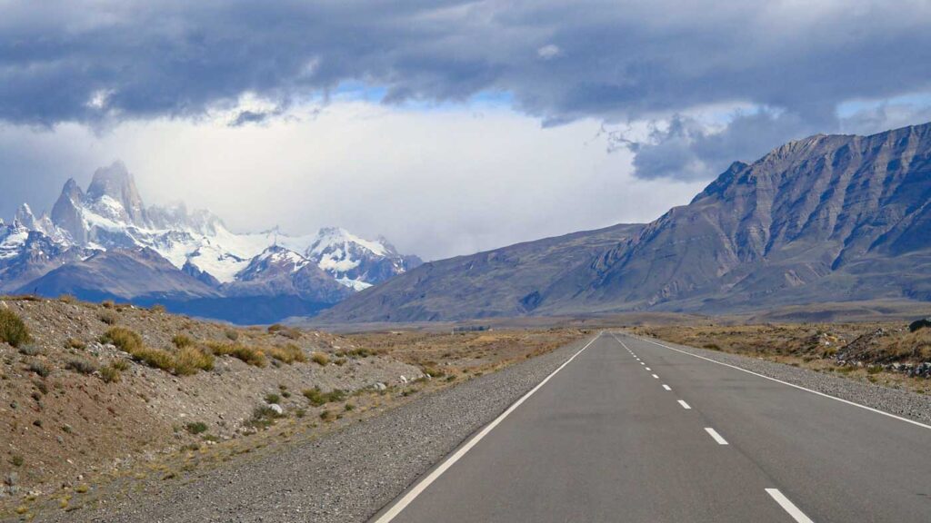 On the road between El Calafate and El Chaltén with Mount Fitz Roy towering in the distance below storm clouds.