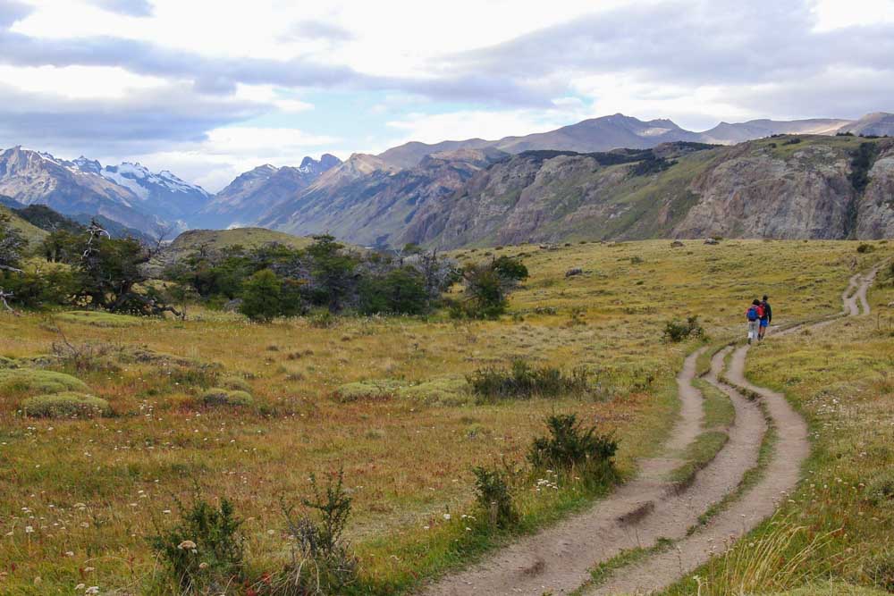 Two hikers with daypacks returning from Laguna Torre.