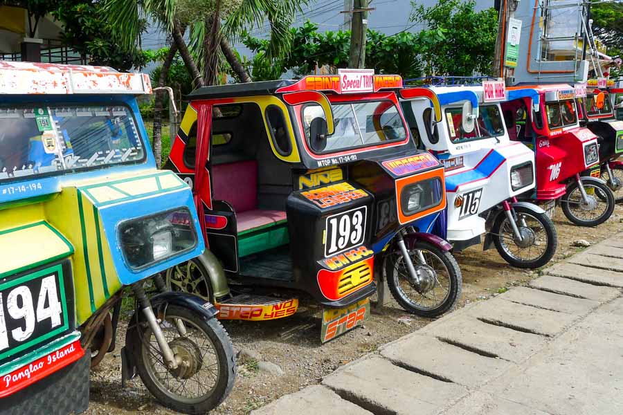 A row of colorful tricycles on Alona Beach, Panglao Island.
