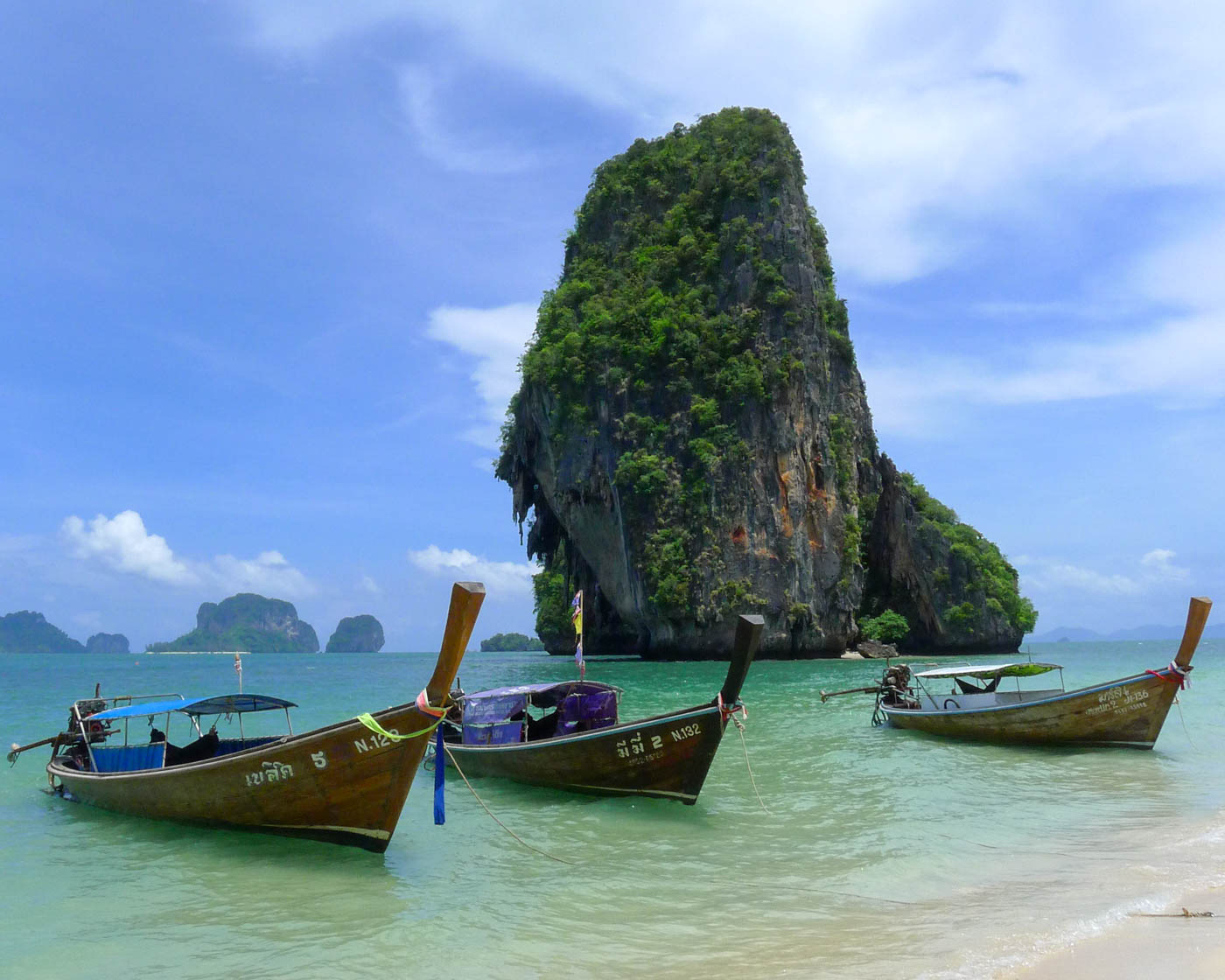 Limestone karsts and longtail boats on famous Phra Nang Beach in Krabi province, Thailand