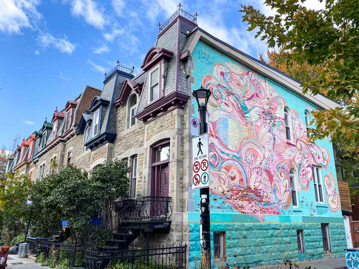 Colorful mural on the side of Victorian row houses in the Plateau-Mont-Royal neighborhood.