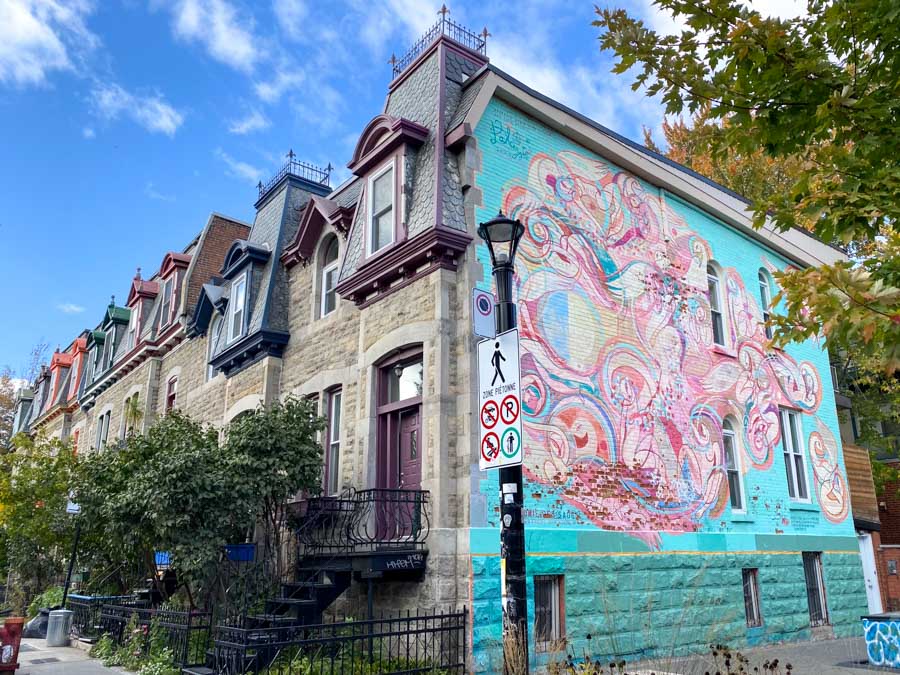 Colorful mural on the side of Victorian row houses in the Plateau-Mont-Royal neighborhood.