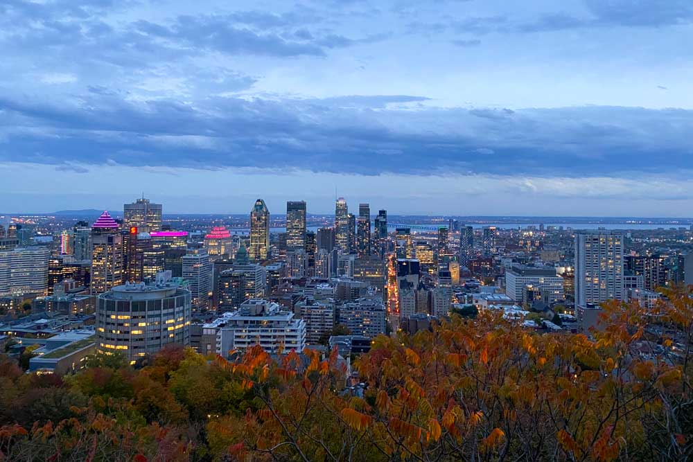 Evening view of the illuminated Montreal skyline from Kondiaronk Belvedere on Mount Royal.