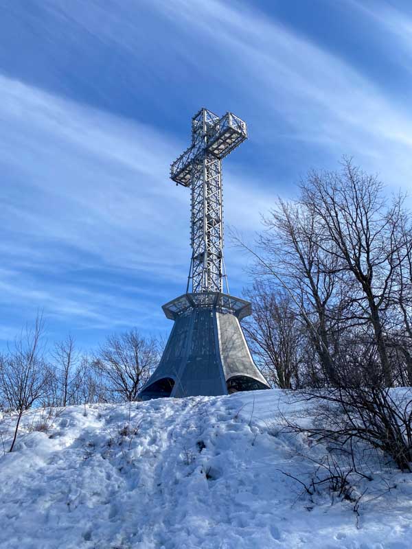 The Mount Royal Cross on a clear day in late spring with snow still on the ground.