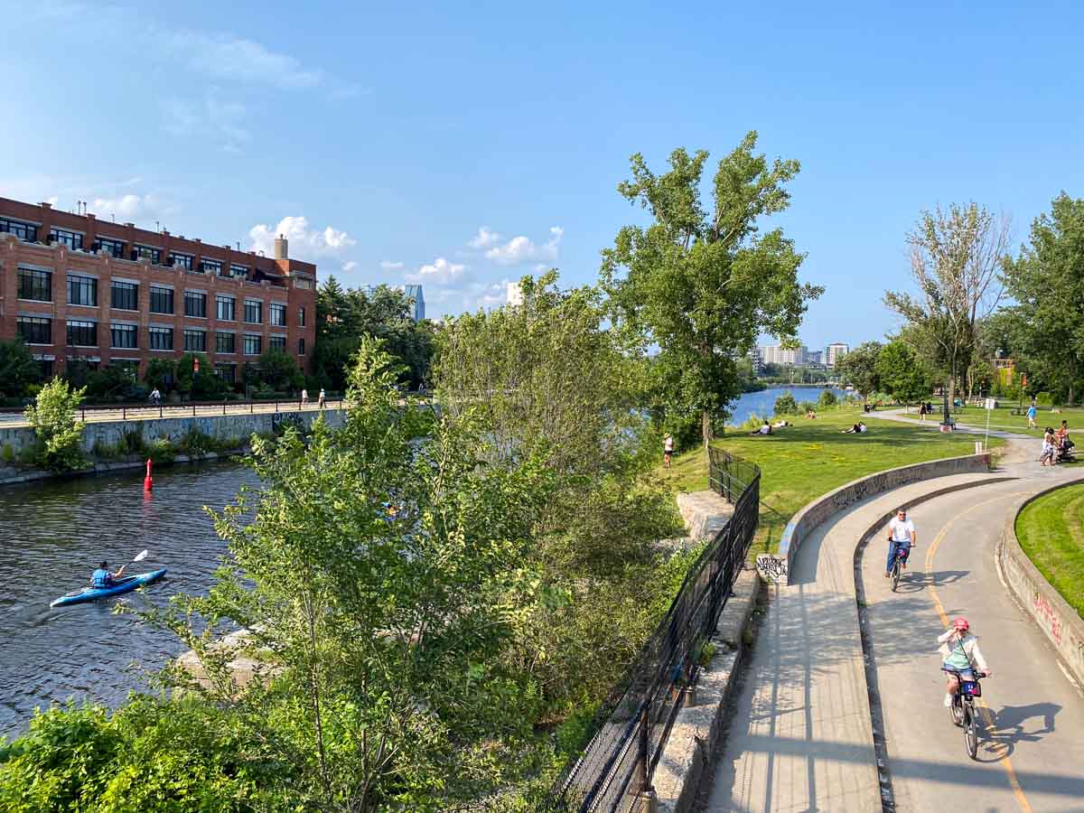 People cycle, walk, kayak, and picnic along the Lachine Canal in Little Burgundy.