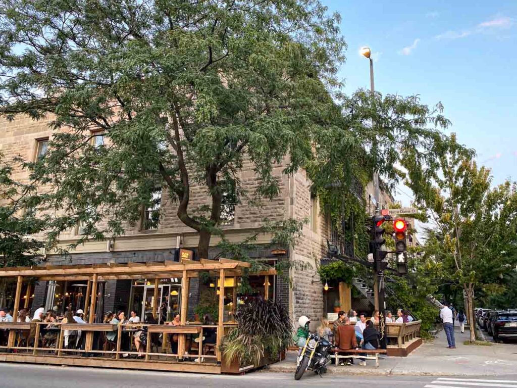 Streetside terrasse seating at a popular bar in Montreal's Saint-Henri neighborhood in the Sud-Ouest.