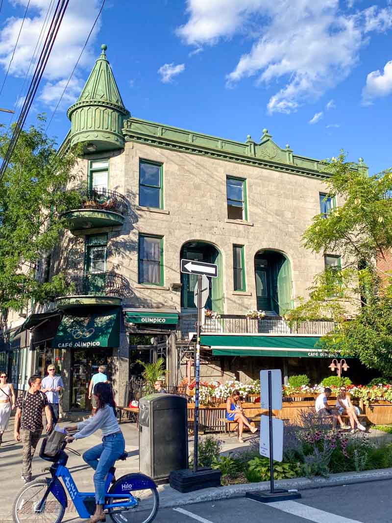 A summer street scene outside the famous Cafe Olimpico in Mile End neighborhood.