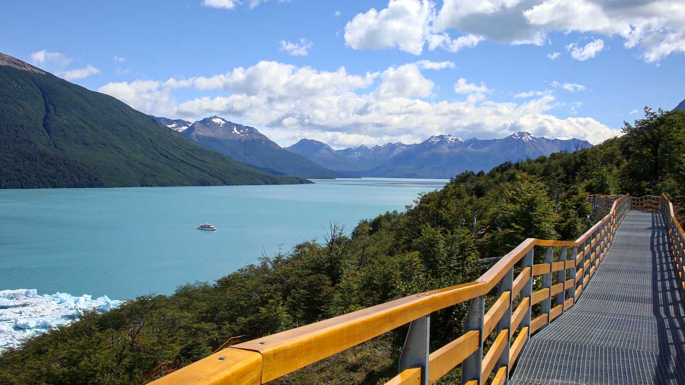 A boat next to icebergs in Lago Argentino, viewed from the elevated walkways next to the Perito Moreno glacier.