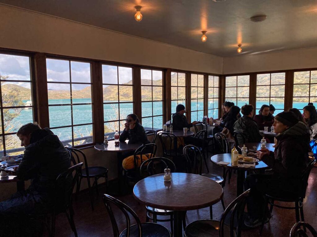 Hikers enjoy lunch, snacks, and coffee at Pudeto cafe while waiting for buses and the catamaran.