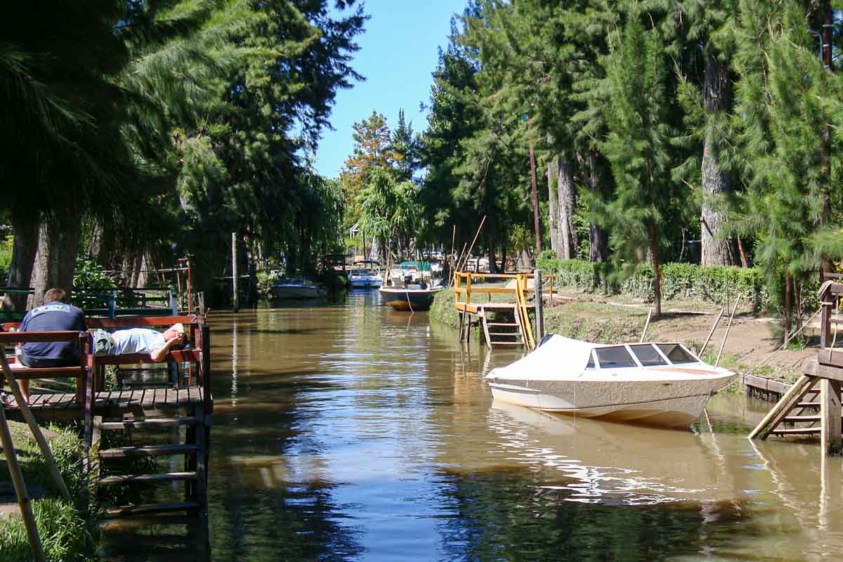 Small boats and wooden docks in a small waterway in Tigre, Argentina.