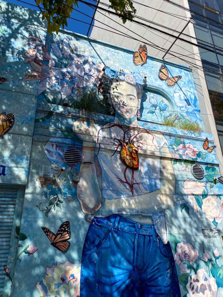 Mural of Frida Kahlo surrounded by flowers and butterflies by street artist Campos Jesses in Palermo Hollywood.