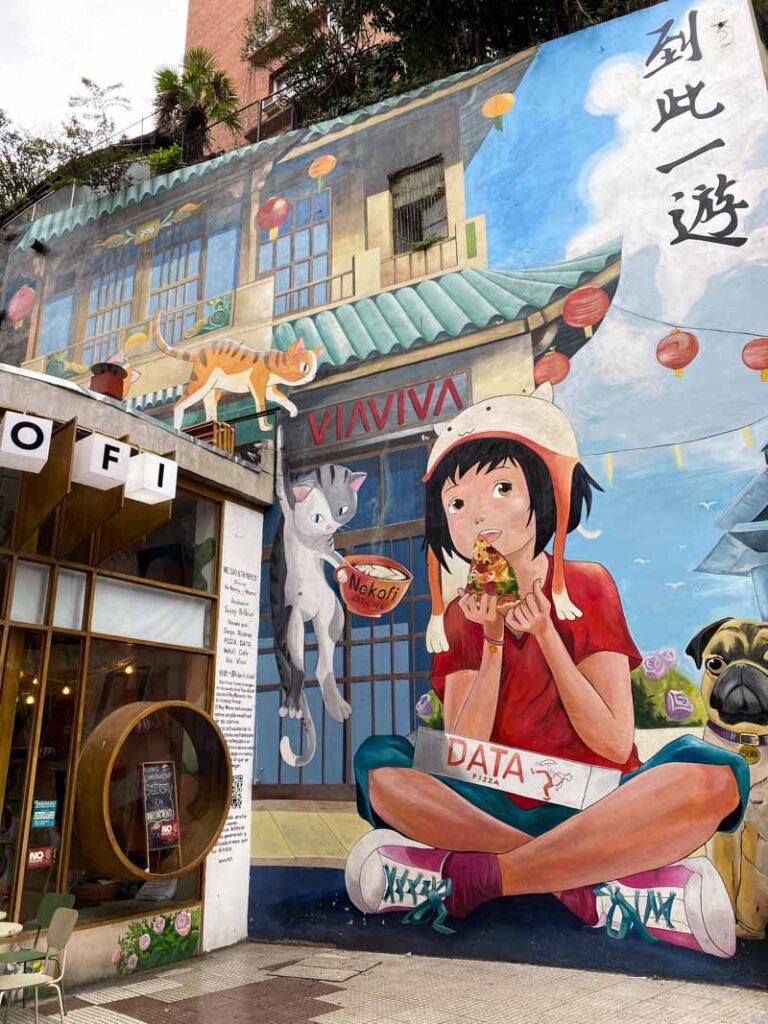 Mural of a girl eating pizza on the Via Viva in the Chinatown neighborhood of Buenos Aires.