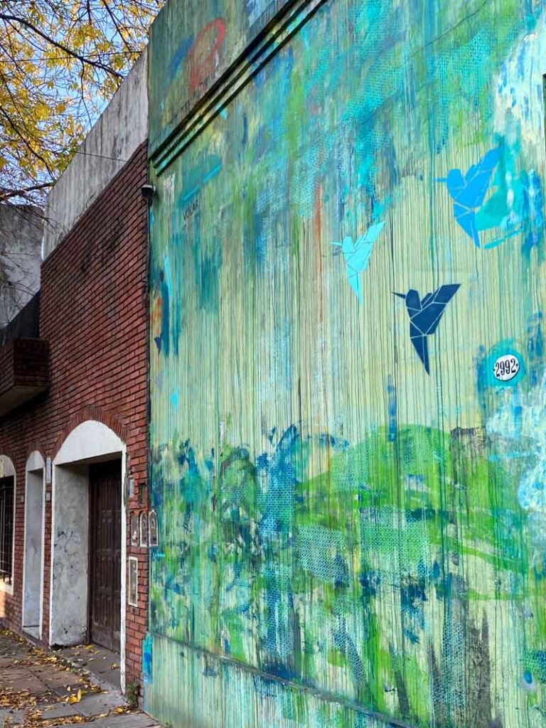 Street art of green and blue origami birds in Colegiales.