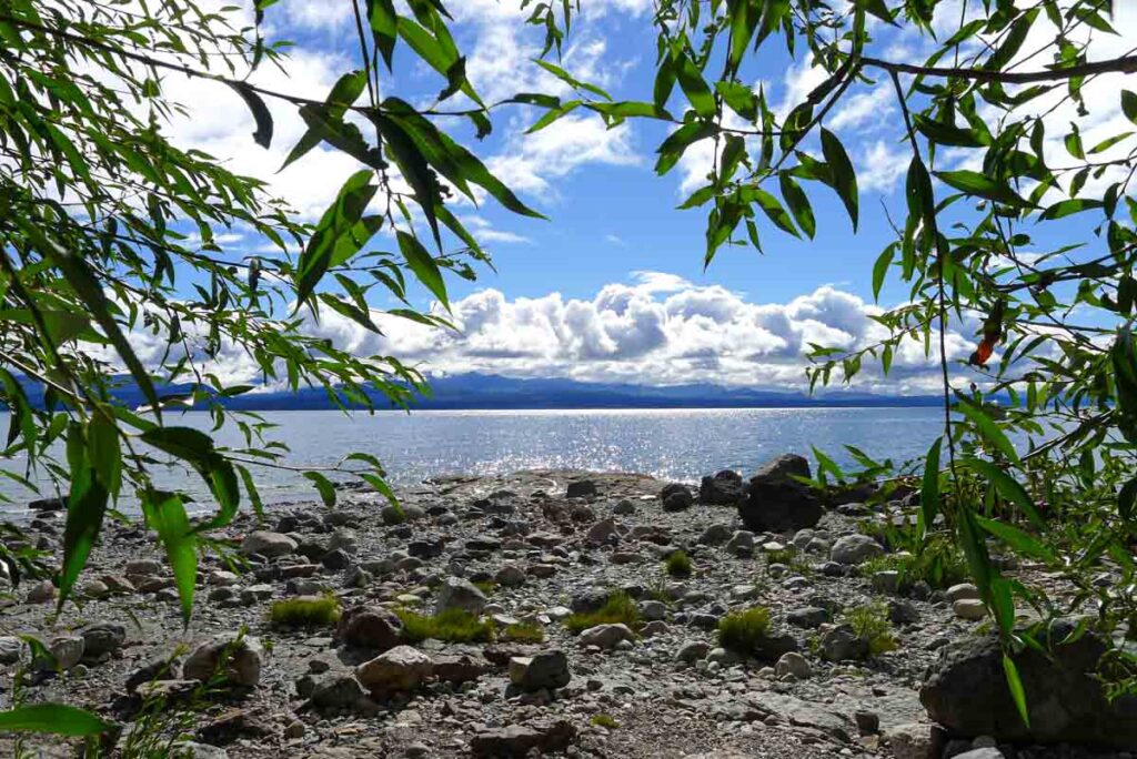 Sparkling blue water and a rocky lakeshore in the Argentinian Lake District.