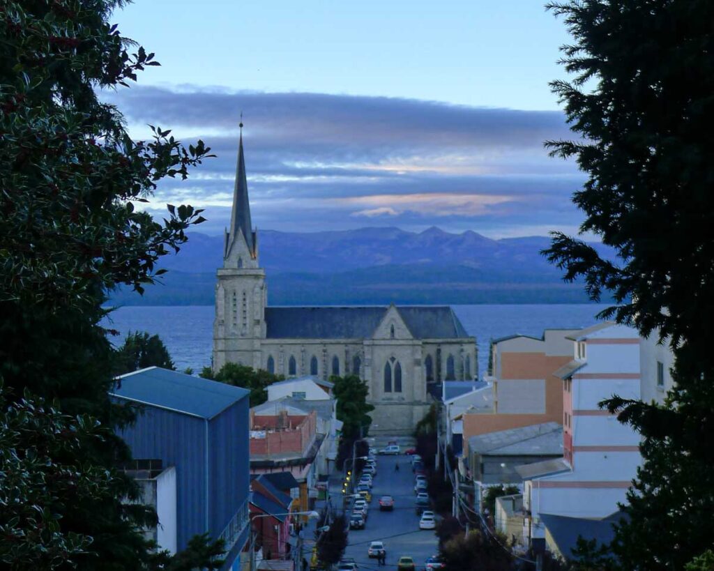 View of Bariloche's cathedral (Catedral Nuestra Señora del Nahuel Huapi) at dusk with the lake in the background.